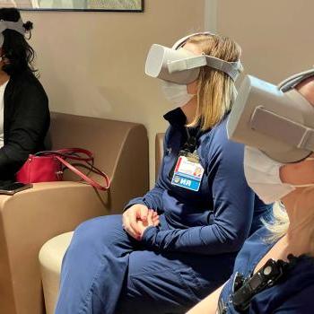 Health care workers wear virtual reality headsets during a study